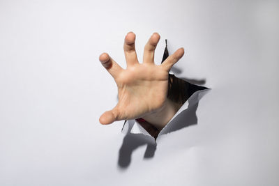 Close-up of woman hand over white background