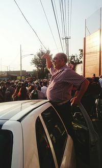 Man in car against sky