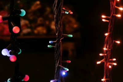 Close-up of illuminated lanterns hanging at night