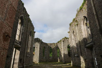 Low angle view of old ruins against sky