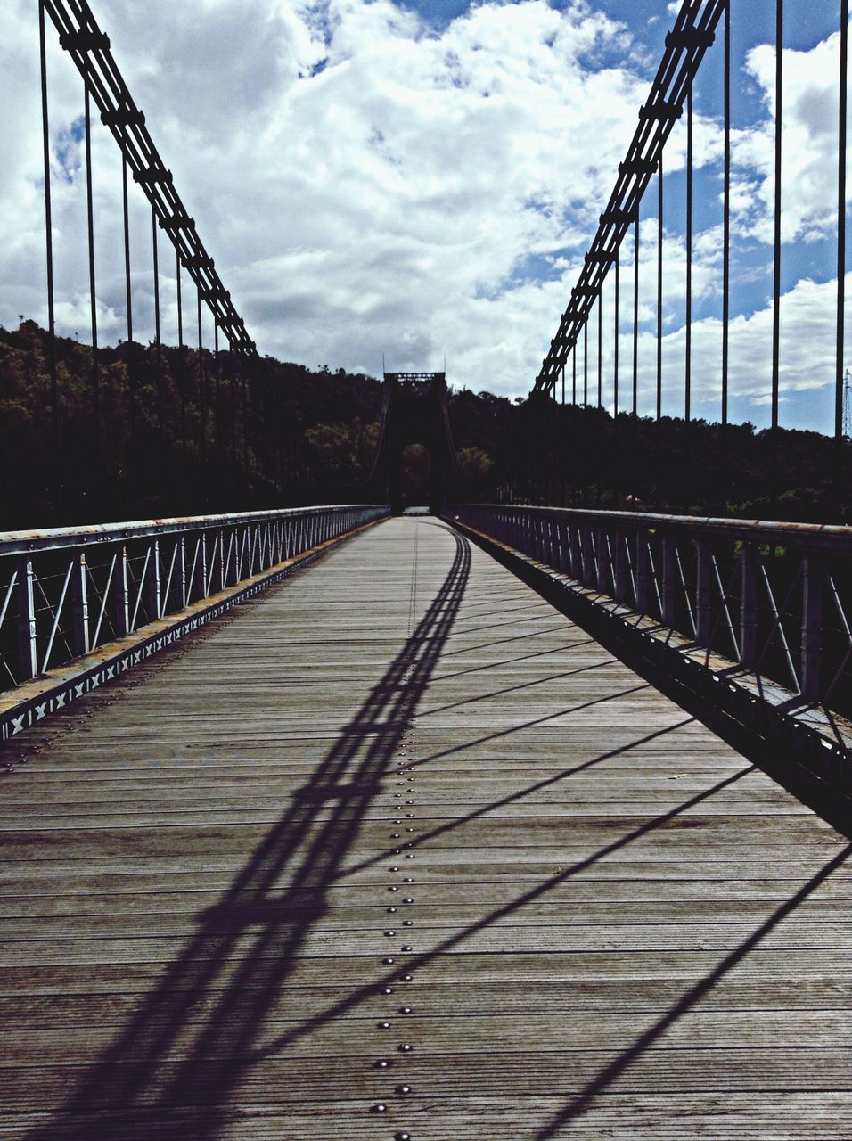 connection, built structure, architecture, low angle view, bridge - man made structure, engineering, sky, suspension bridge, cloud - sky, metal, bridge, cable-stayed bridge, cloudy, cloud, transportation, day, steel cable, outdoors, cable, metallic