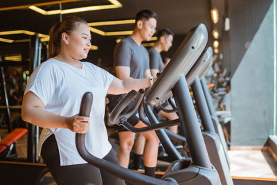 Portrait of young woman exercising in gym