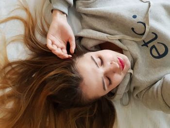 High angle view of woman lying on bed