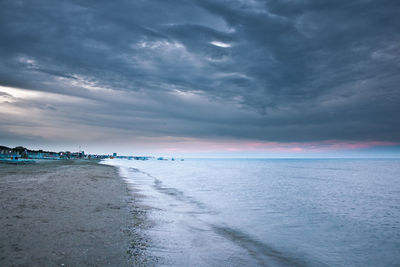 Scenic view of sea against cloudy sky