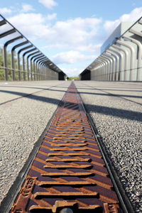 Surface level of railroad track against sky