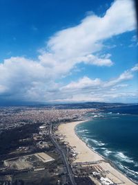 High angle view of sea and cityscape against sky