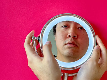 Portrait of young man holding camera