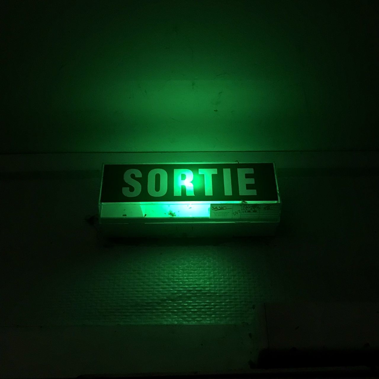 CLOSE-UP OF ILLUMINATED CLOCK ON WALL