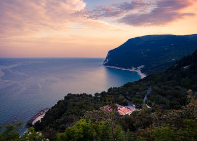 High angle view of bay against sky at sunset