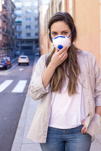 Portrait of beautiful woman standing on street in city