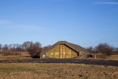 Scenic view of field against clear blue sky