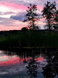 Scenic view of lake against romantic sky at sunset