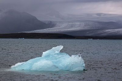 Scenic view of frozen lake against mountain range