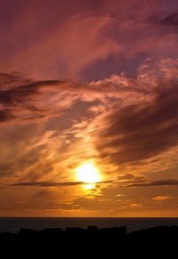 Scenic view of dramatic sky over sea during sunset