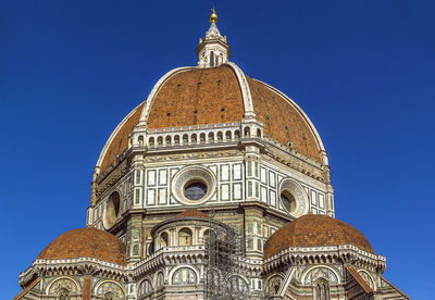 Low angle view of a building against blue sky