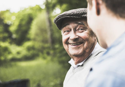 Portrait of smiling senior man looking at his grandson