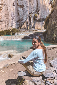 Portrait of man sitting on rock