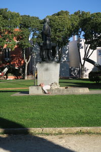 Sculpture in cemetery against built structure