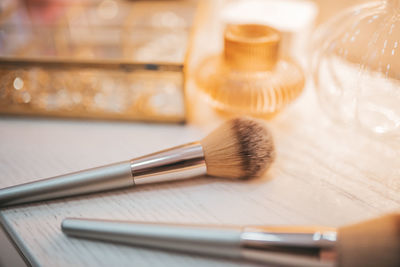 Close-up of make-up brushes on table