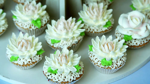 A variety of delicious desserts, cupcakes, cream cakes, whipped cream, flowers made with cream.