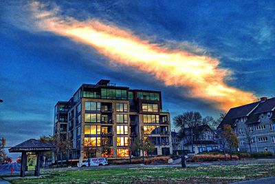 Buildings against cloudy sky at sunset