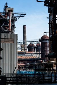 Low angle view of factory against sky