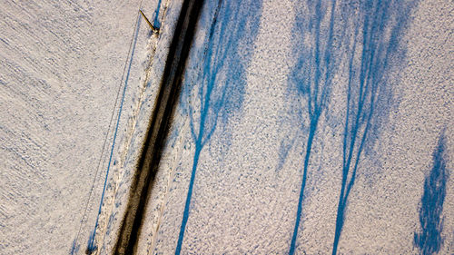 High angle view of tire tracks on road