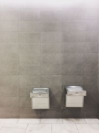 Empty seats on tiled floor against wall