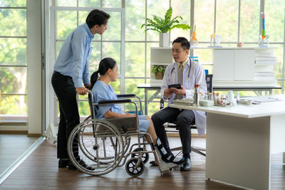 Side view of man using laptop on table