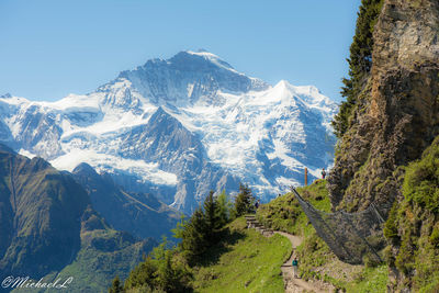 Scenic view of snowcapped mountains against clear sky