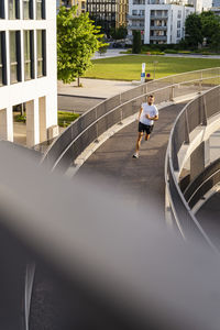 Man jogging on elevated walkway