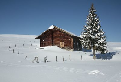 Mountain cabin on snow covered landscape