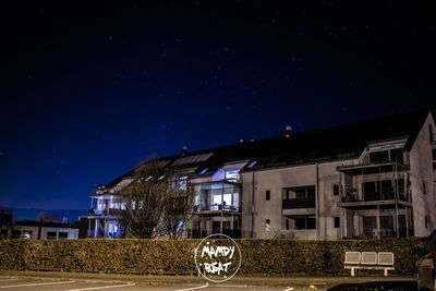 View of residential building against sky at night