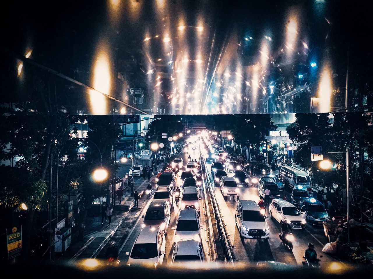 HIGH ANGLE VIEW OF ILLUMINATED STREET AT NIGHT