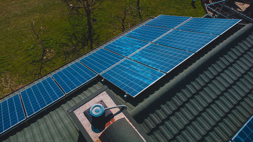 Low angle view of water spraying roof against sky