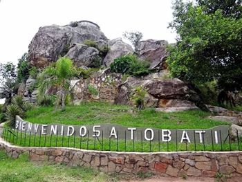 Information sign on mountain against sky