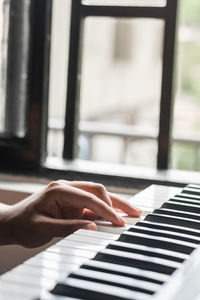 Cropped hand playing piano