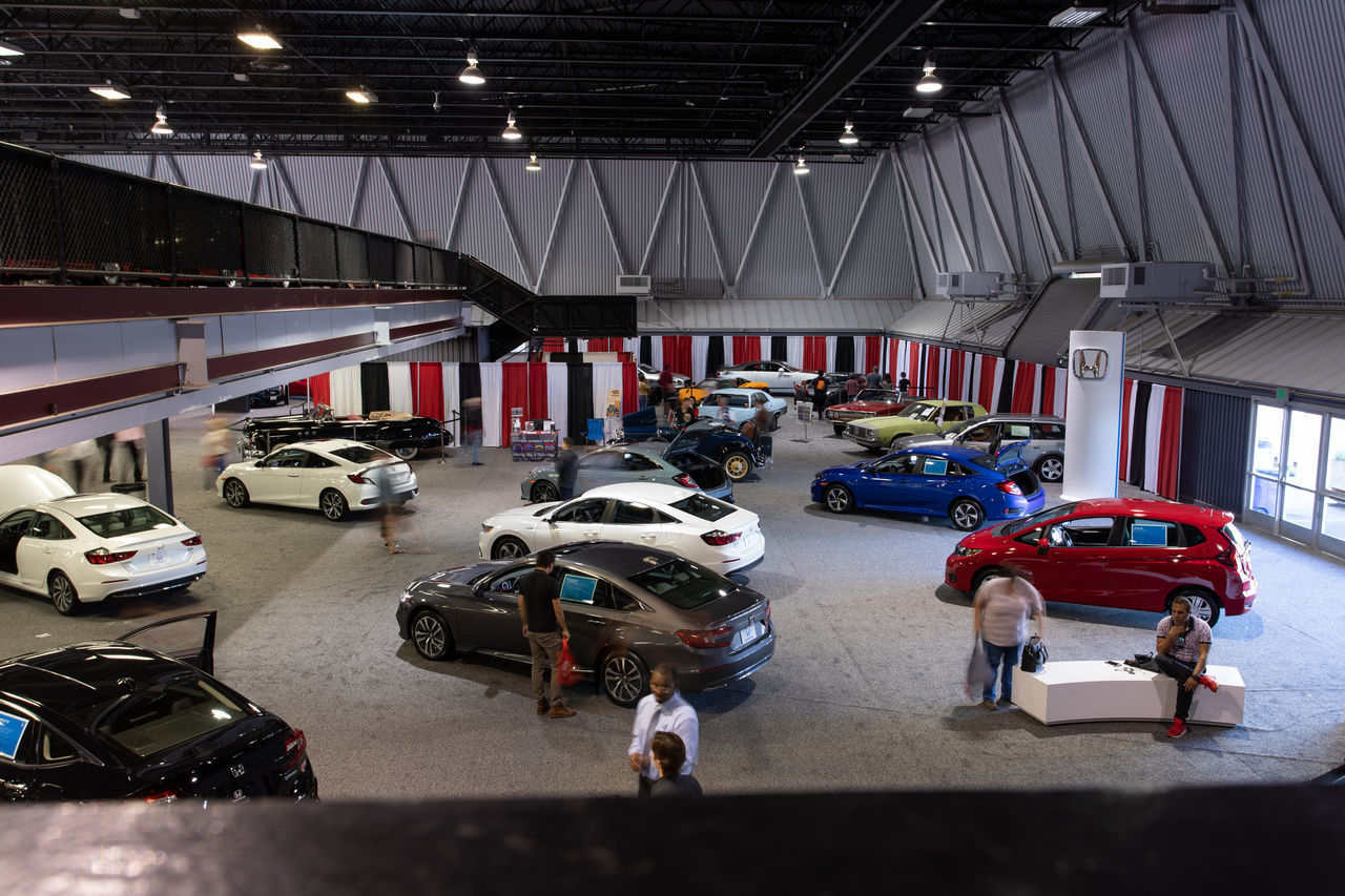 HIGH ANGLE VIEW OF PEOPLE IN PARKING LOT