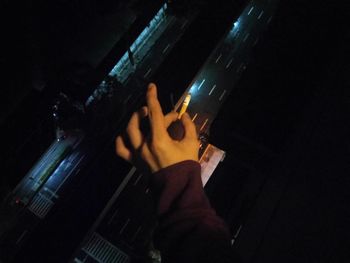 Low angle view of man playing guitar at music concert