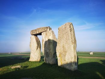 Stone structure on field against sky