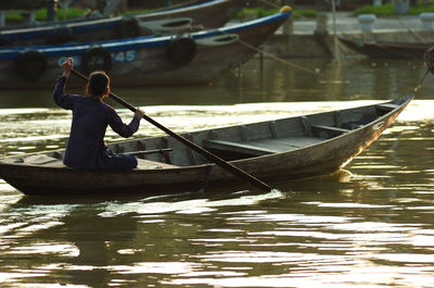 Man sitting on boat in river