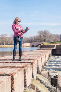 Full length of woman standing against sky