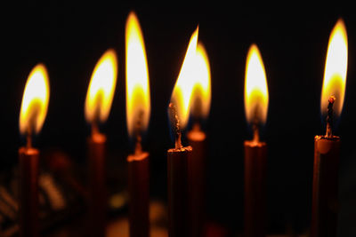 Close-up of lit candles in temple