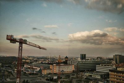 View of cityscape against cloudy sky