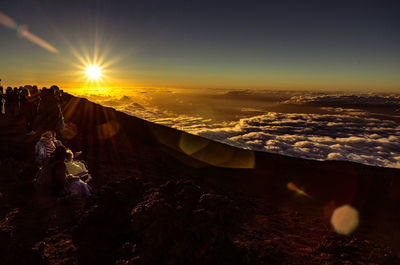 High angle view of people hiking on mountain during sunrise