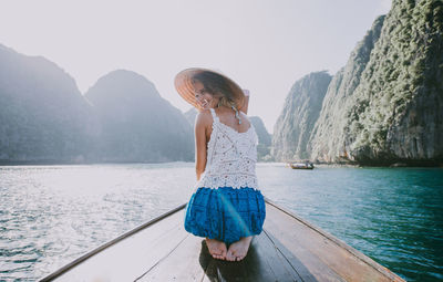 Full length of woman on lake against mountains