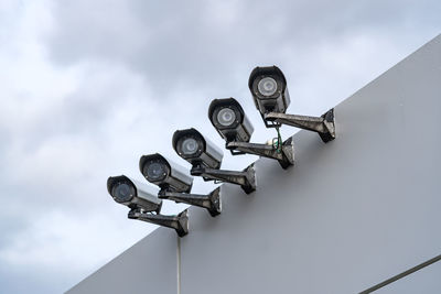 Low angle view of coin-operated binoculars against sky