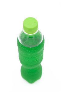 Close-up of green bottle against white background