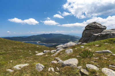 Scenic view of rocky mountains against cloudy sky