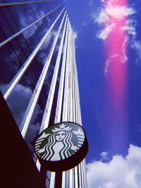 Low angle view of glass building against sky